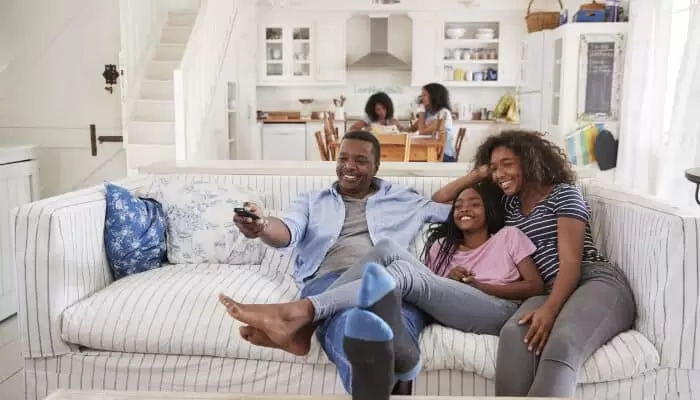 Home Comfort Father Watching Tv With Teen Daughters
